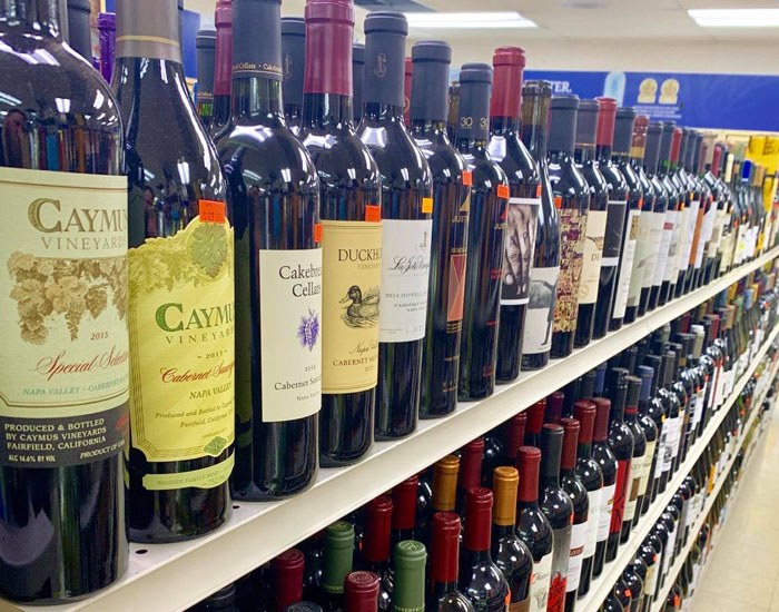 Rows of wine bottles on the shelf at Benstein Liquor